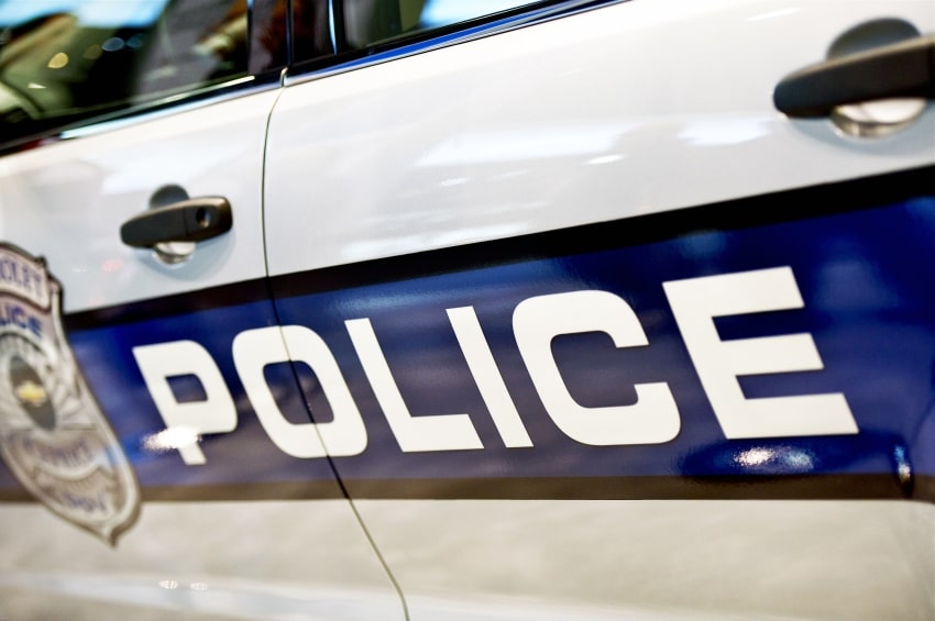 Voiture de police avec gyrophares allumés lors d'une interception routière, illustrant les conséquences d'une fuite policière sur la suspension du permis de conduire.